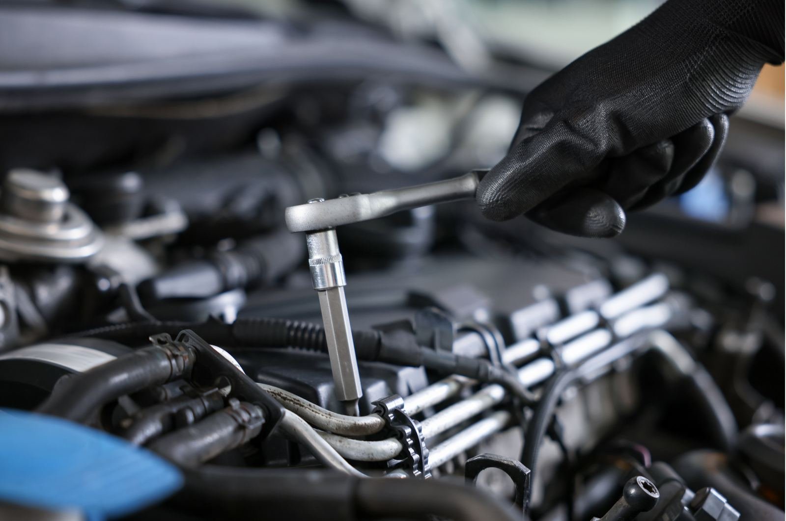 Technician torquing an engine bay component