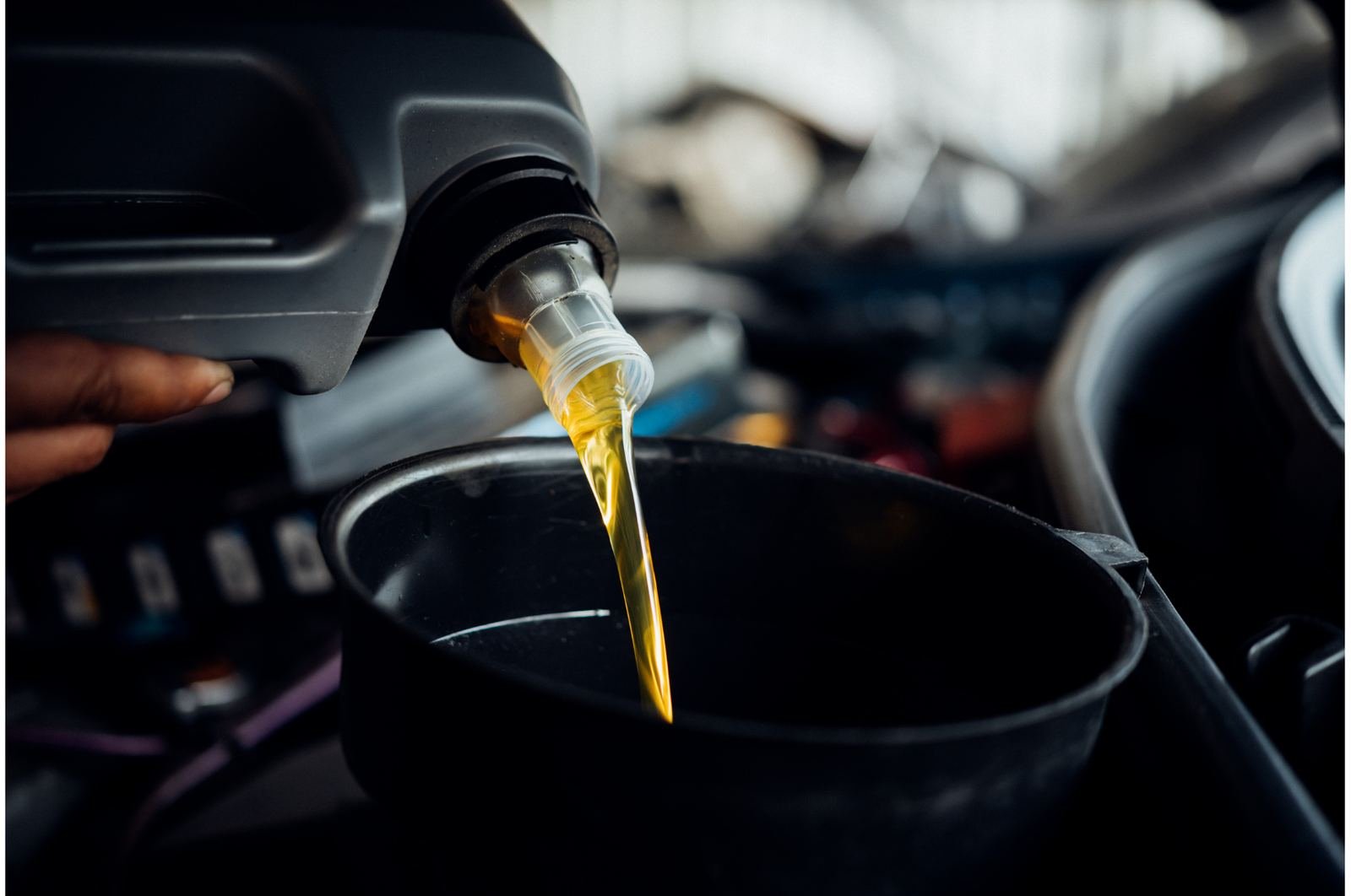 Fresh oil being poured during an oil change